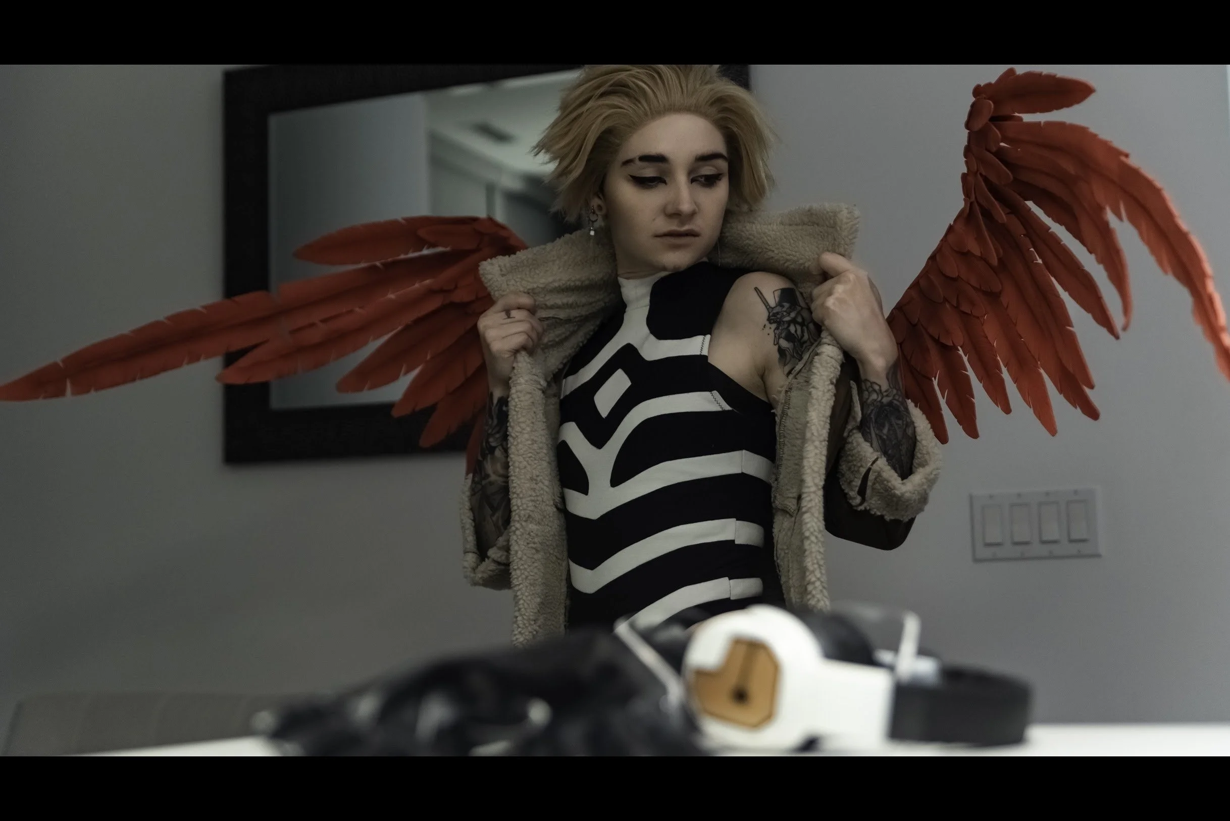 Hawks begins to remove his coat.