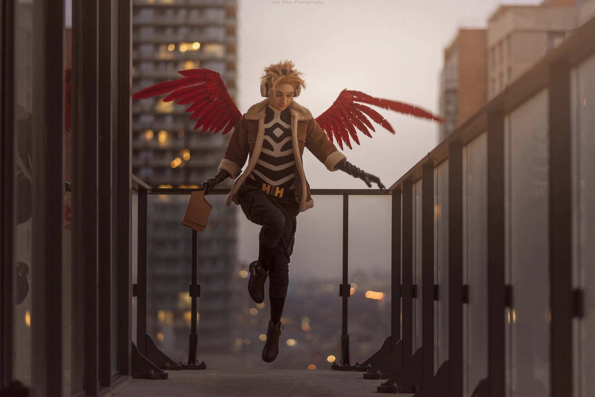Hawks lands via the balcony of a downtown condo, carrying a six pack of beer in one hand.