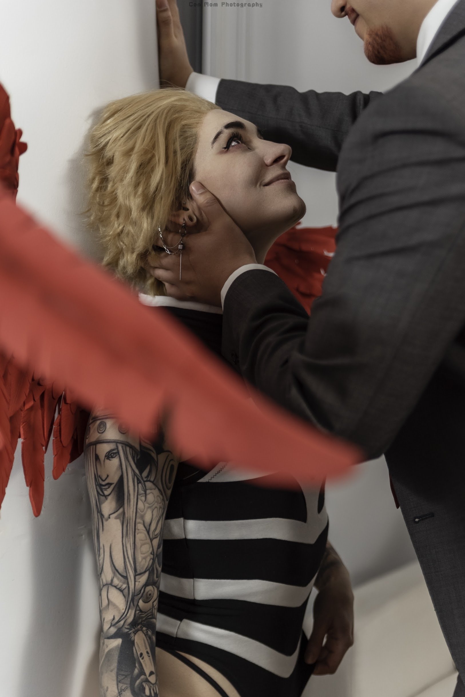 Hawks, now pinned against the pillar previously obscuring his guest, who is now revealed to be much taller than him, and with auburn facial hair.