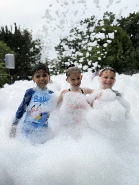 Kids playing in a big cloud of foam during a backyard FoamZone Long Island party.