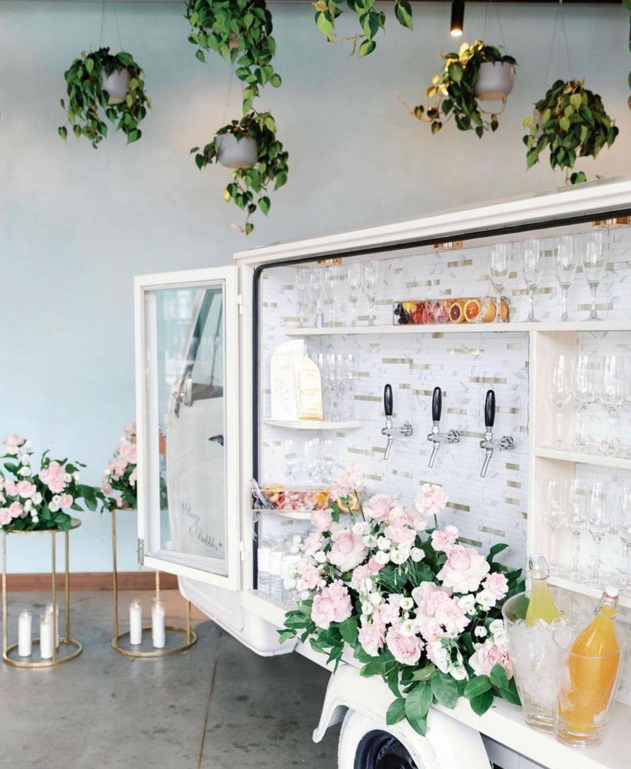 champagne bar cart with fresh greenery and floral arrangements