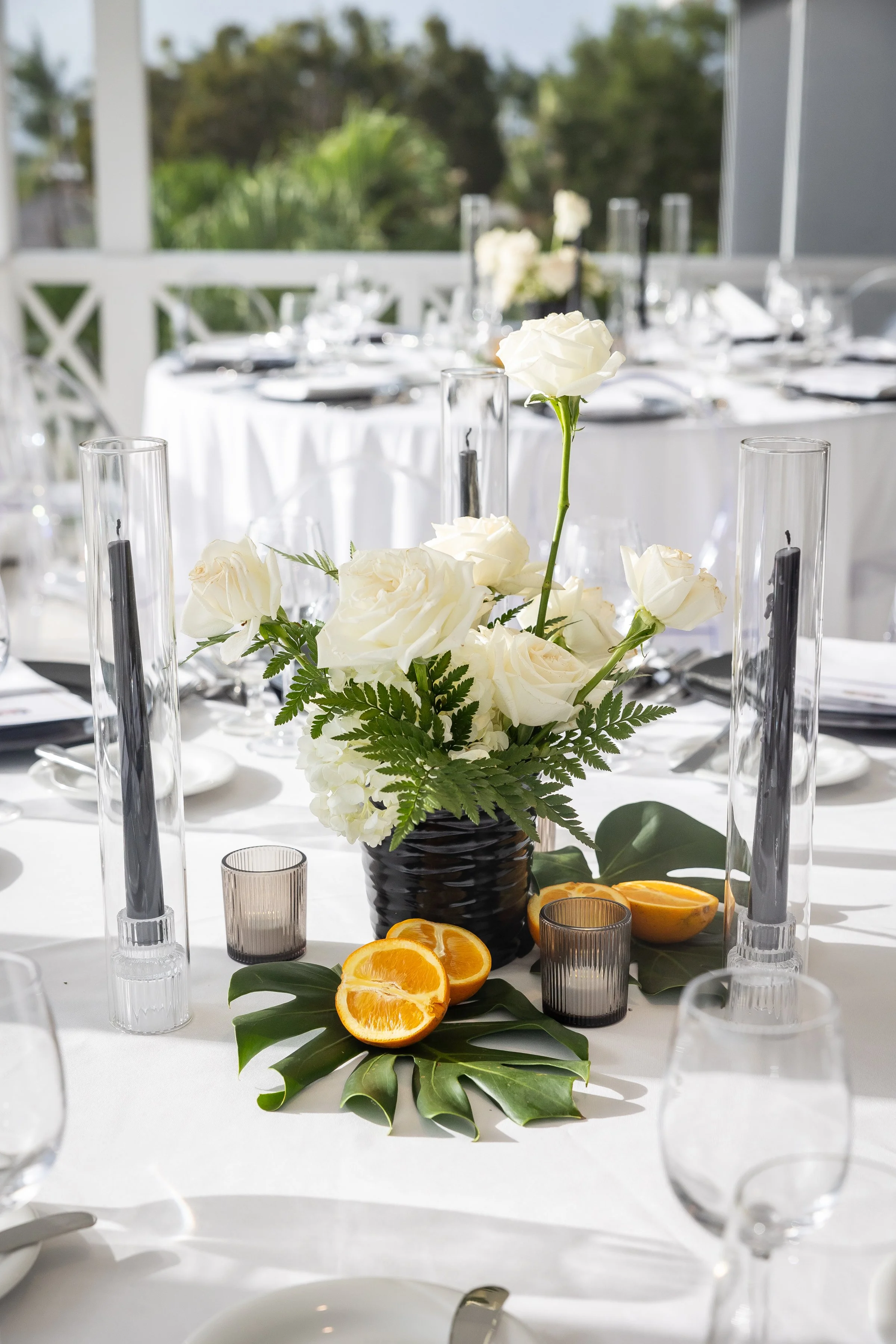 Roses and citrus centerpiece for formal event.