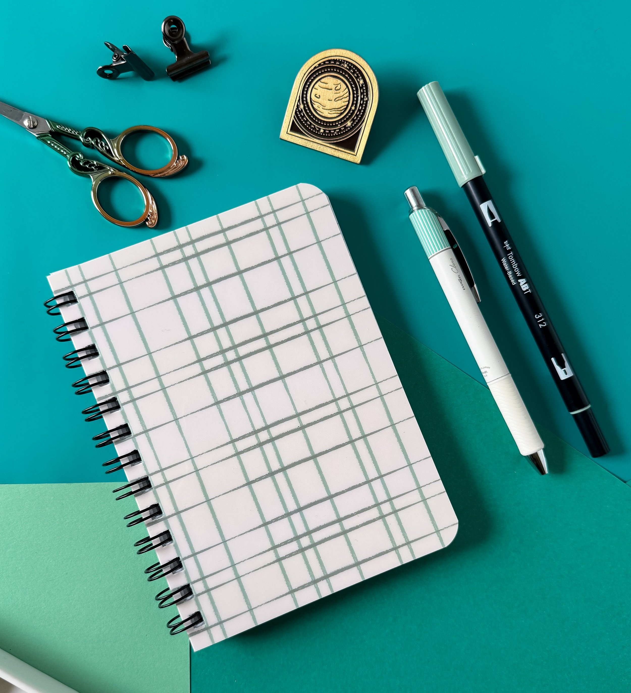 spiral bound notebook with lines pages and shiny cover with hand drawn line pattern