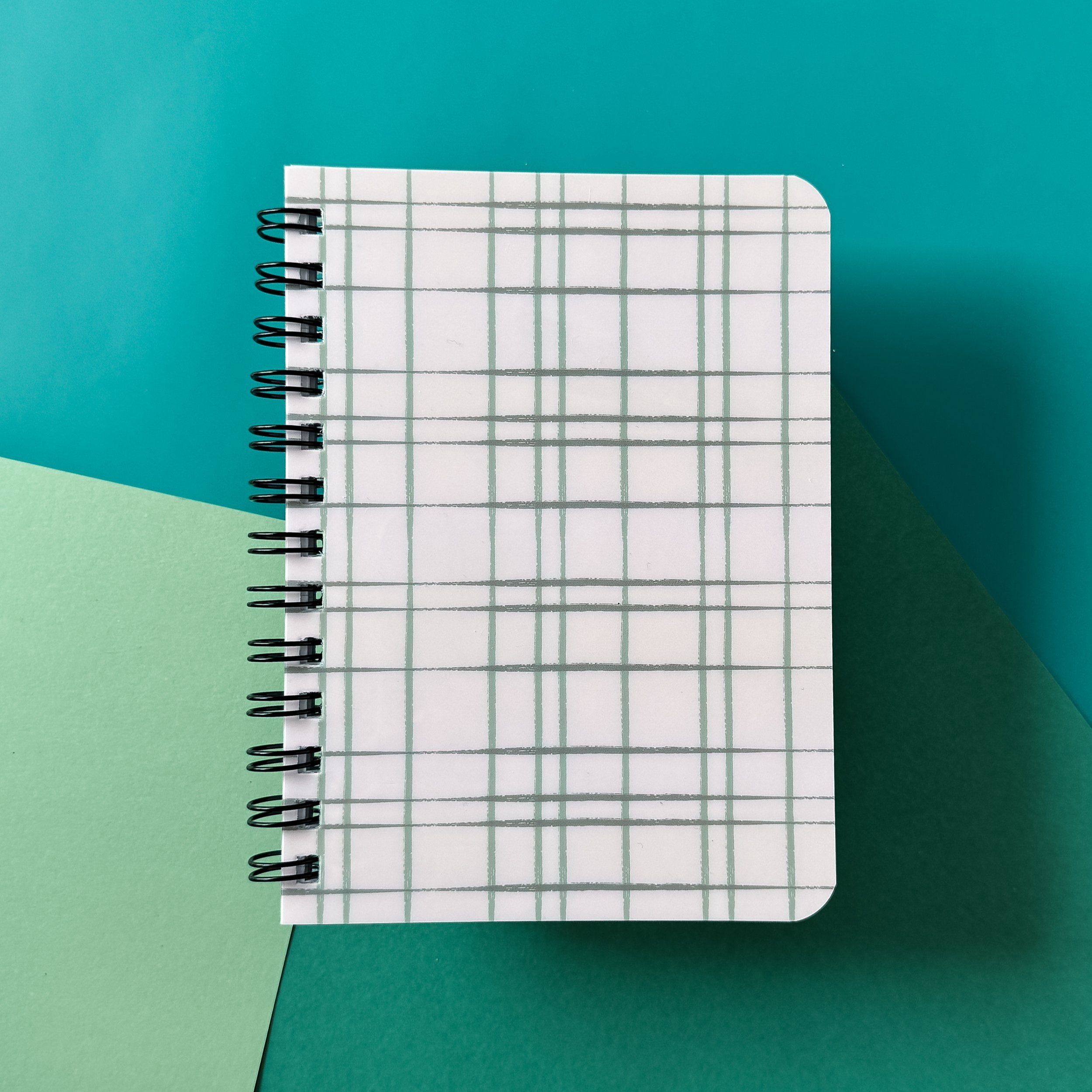 spiral bound notebook with lines pages and shiny cover with hand drawn line pattern