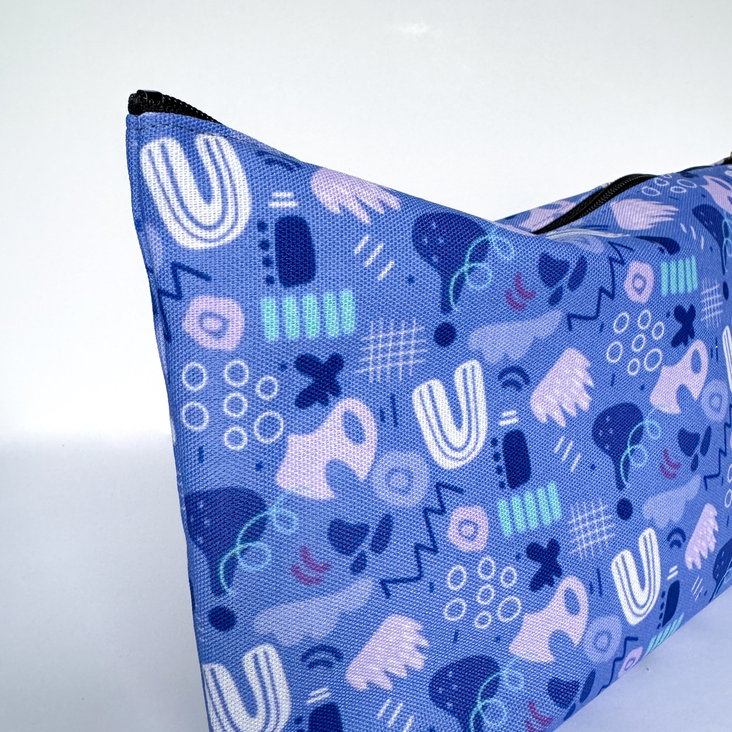 close up of abstract shapes and lines pattern in a fabric pouch perfect for gifting, traveling and as a pencil case