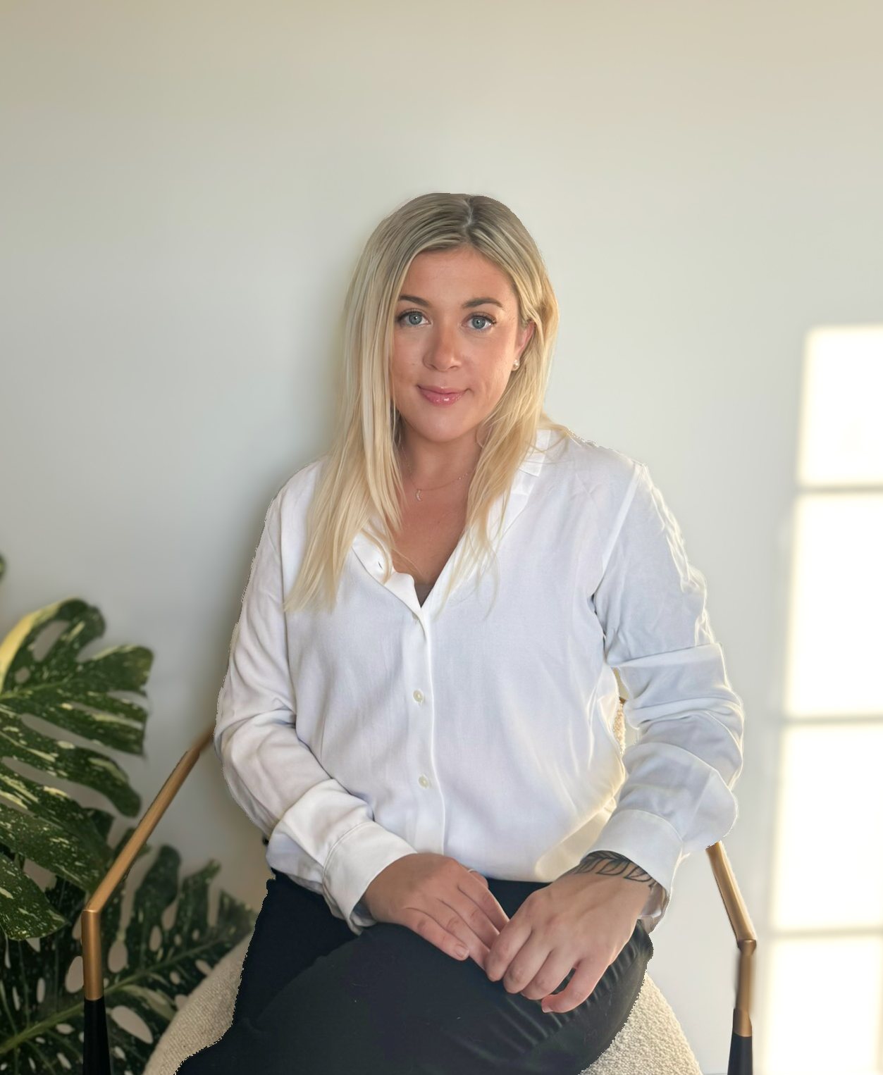Portrait of a Vivid Design Studios team member seated in a bright studio setting.