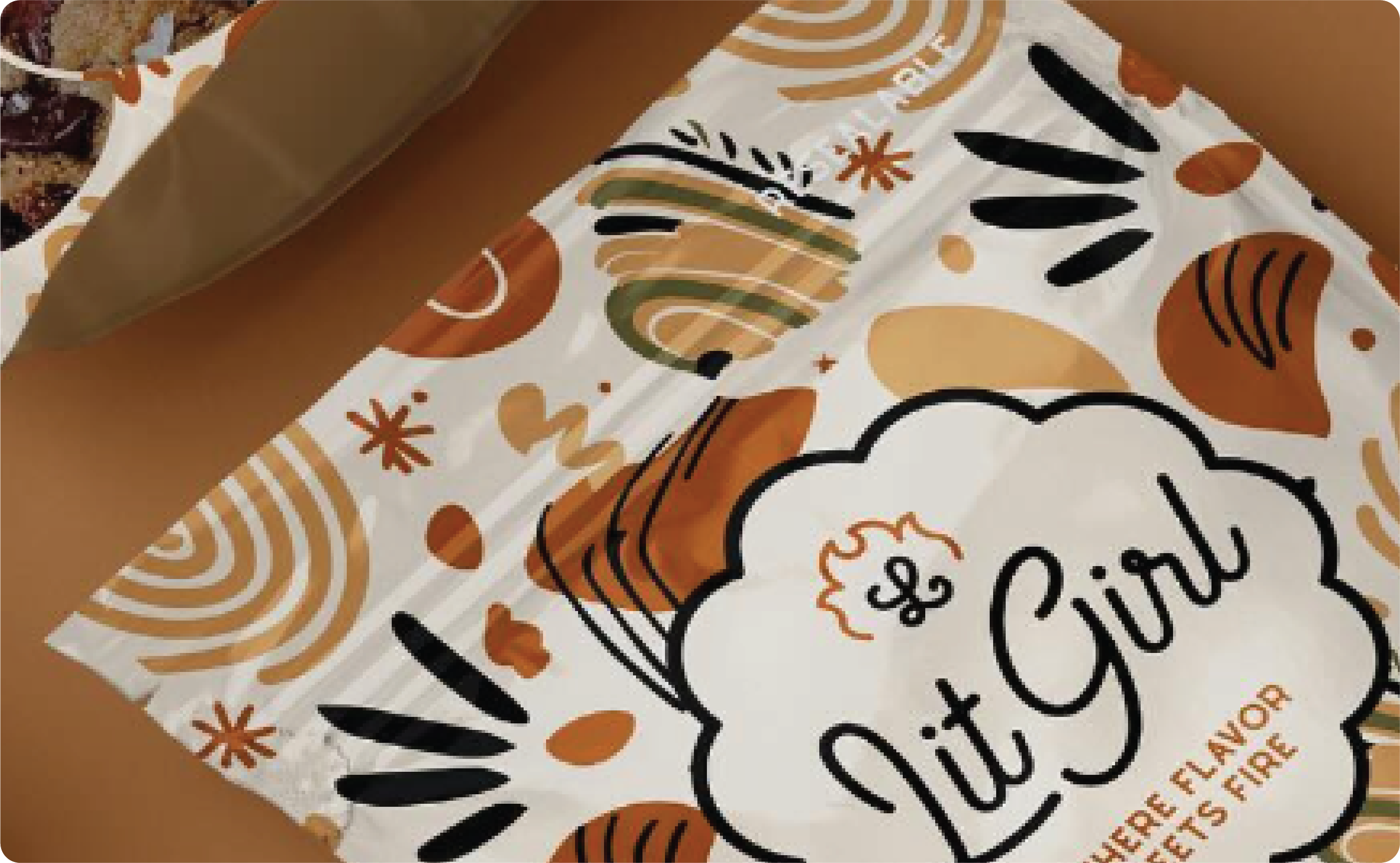 Close-up of a decorative paper bag with autumn-themed patterns and text on a brown background.
