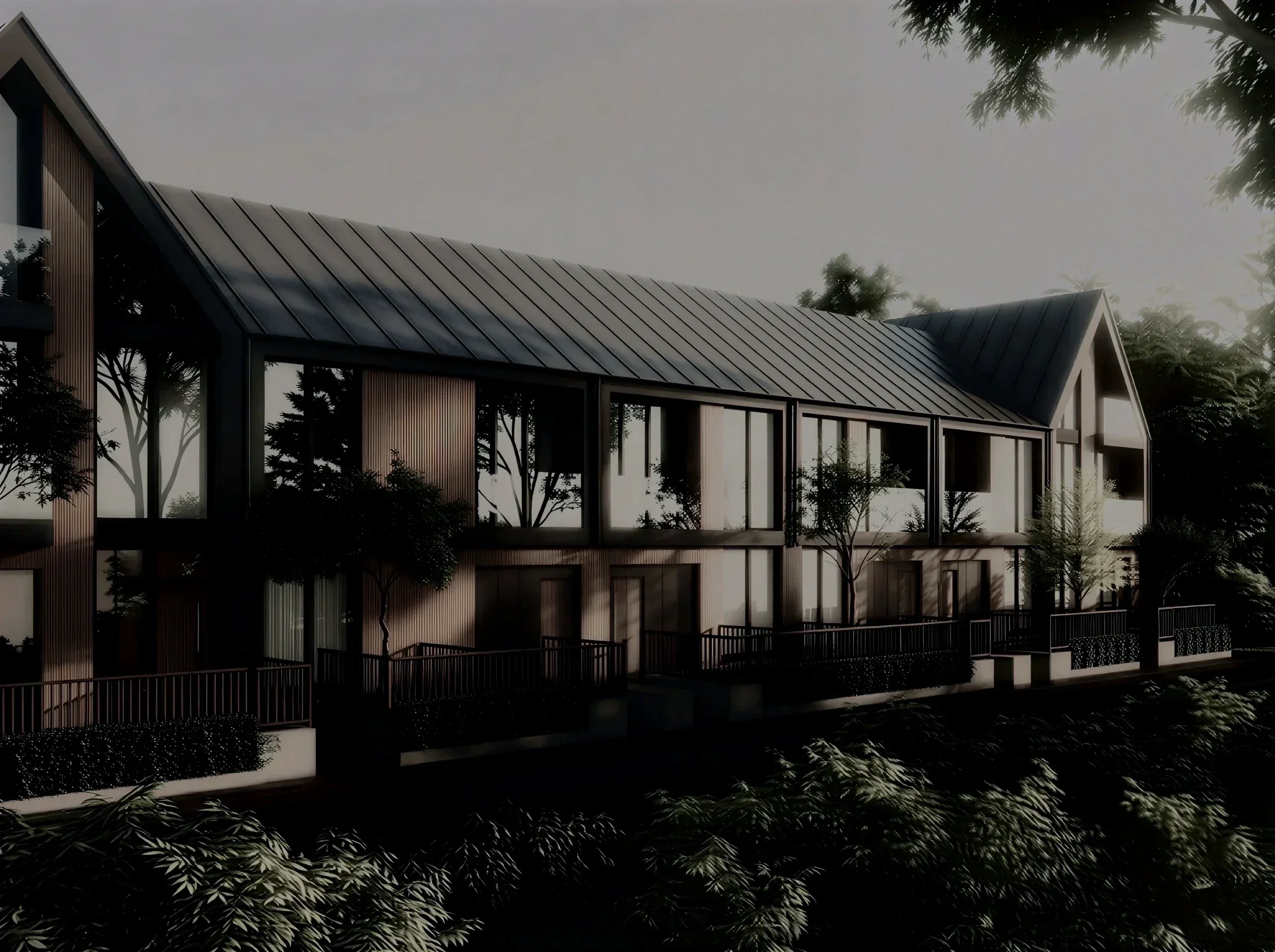Modern multi-story house with black and white exterior, pitched roof, surrounded by trees.