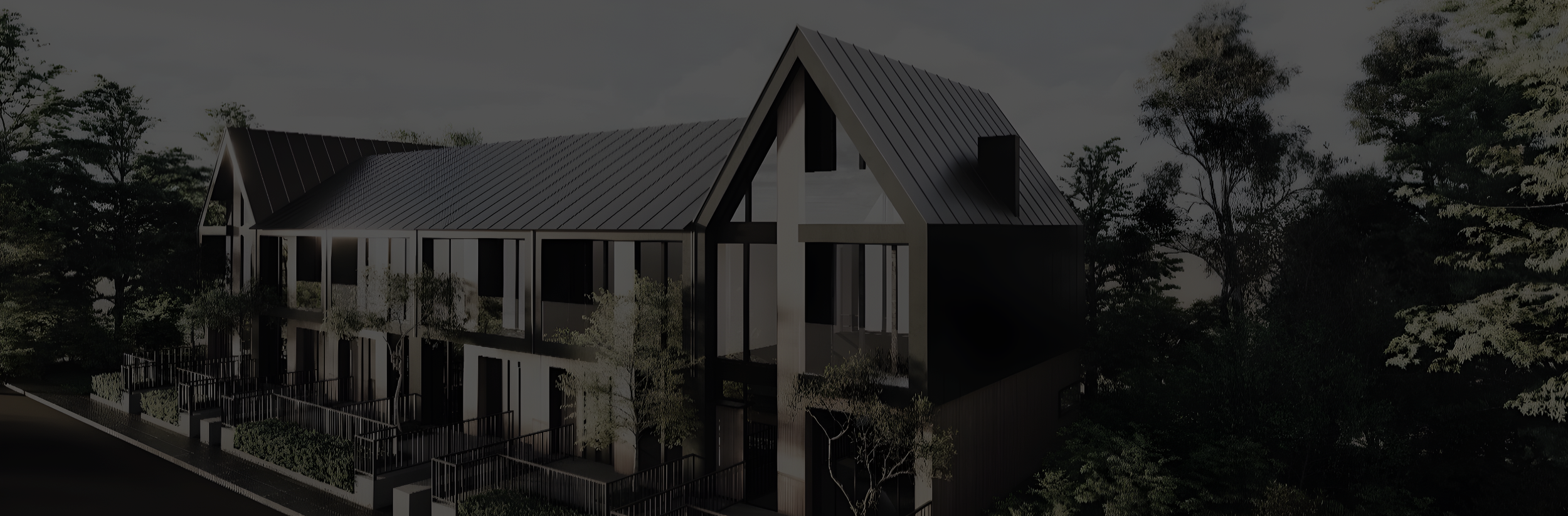 Modern multi-story house with black and white exterior, pitched roof, surrounded by trees.