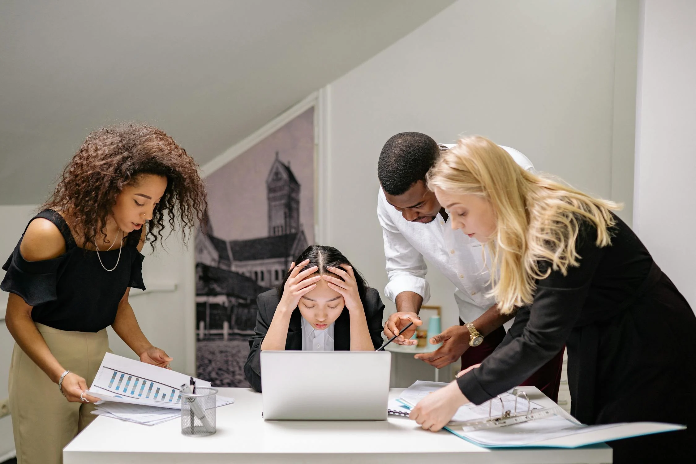 Business team members feeling stressed and overwhelmed during a meeting or discussion in an office.