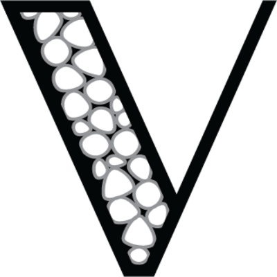 Close-up of a black jacket with a white boutonnière or floral decoration on the lapel.