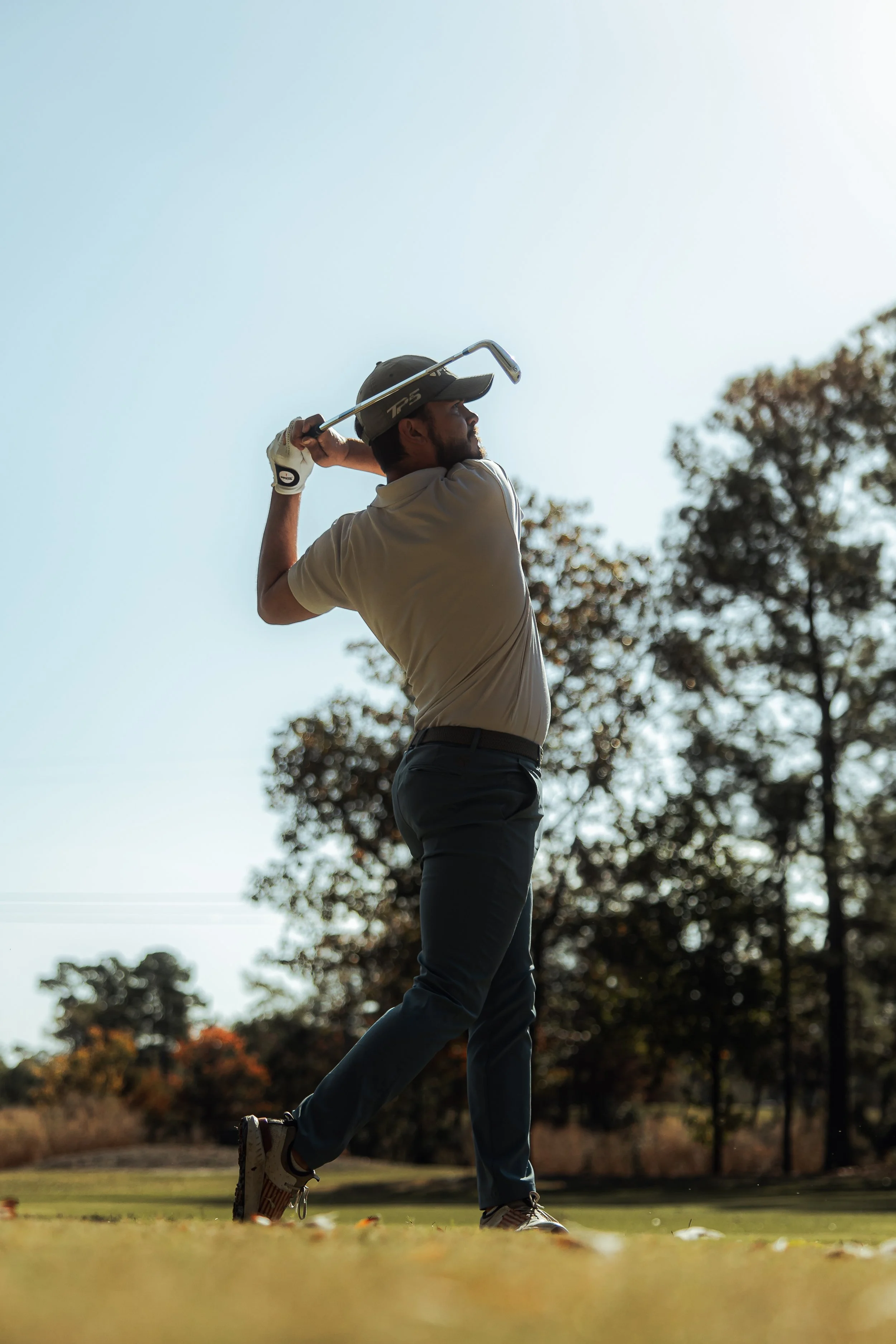 A golfer finishes his swing at the Liberty Christian Academy Missions Tournament.