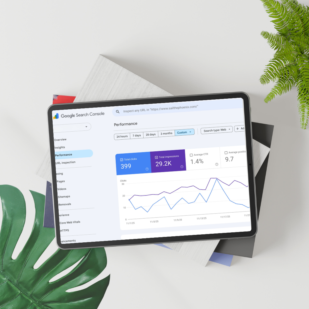 Tablet displaying Google Search Console analytics with performance metrics, placed on white surface with a green leaf and potted plant nearby.
