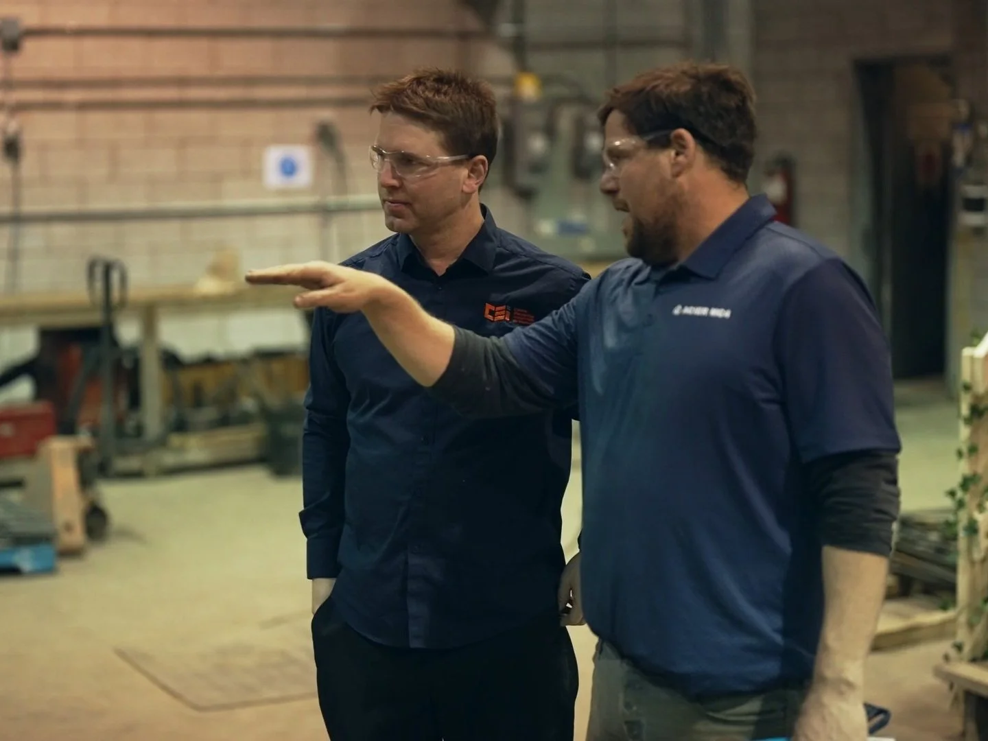 Managers discussing work at industrial warehouse