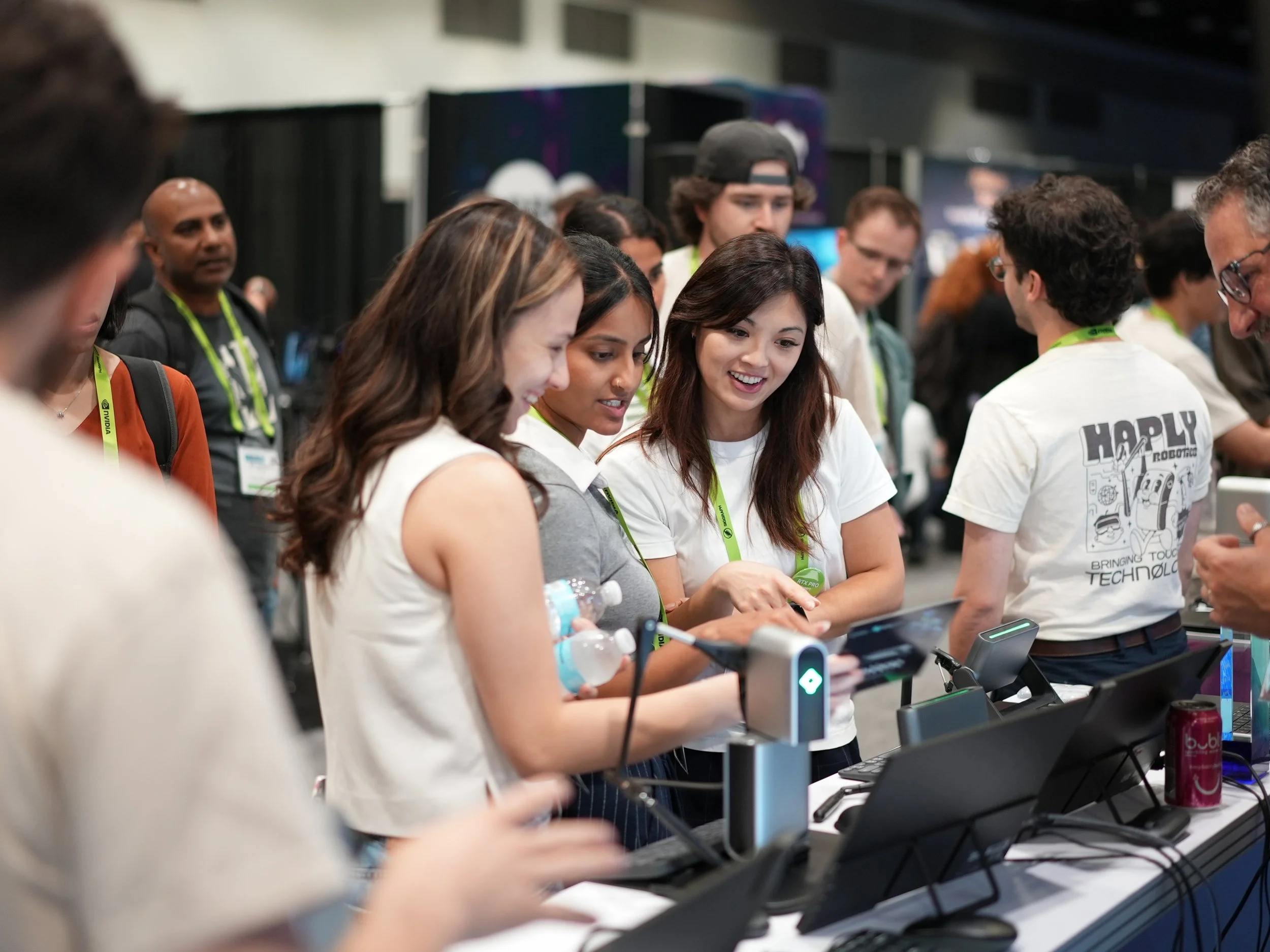 Attendees viewing the Haply Robotics booth at SIGGRAPH 2025