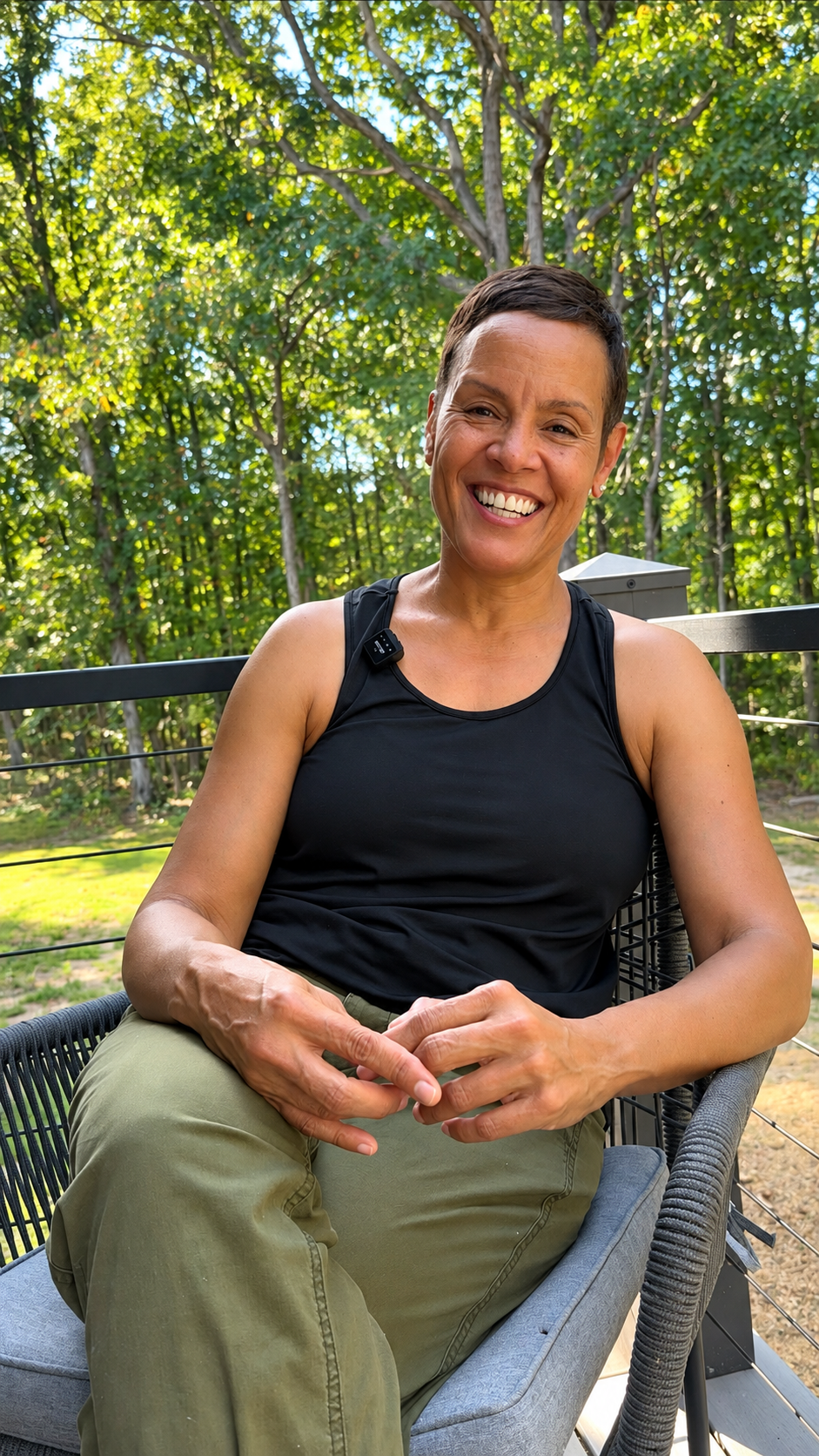 Smiling Woman on a Sunlit Deck.png