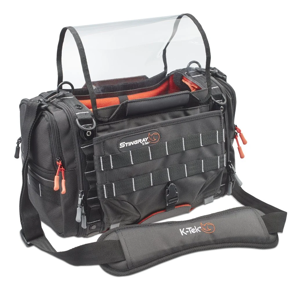Black camera or utility bag with multiple compartments and a clear plastic cover on top, branded with "Stingray" and "K-Tek" logos, designed for carrying photography or electronic gear.
