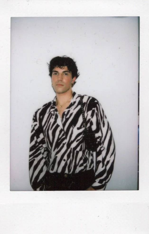 Person in a zebra print shirt against a plain background.