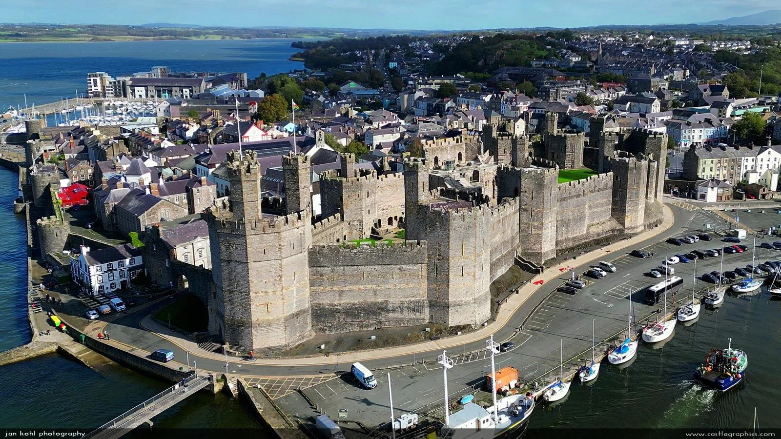 Bangor to Caernarfon taxi service with aerial view of Caernarfon Castle in North Wales
