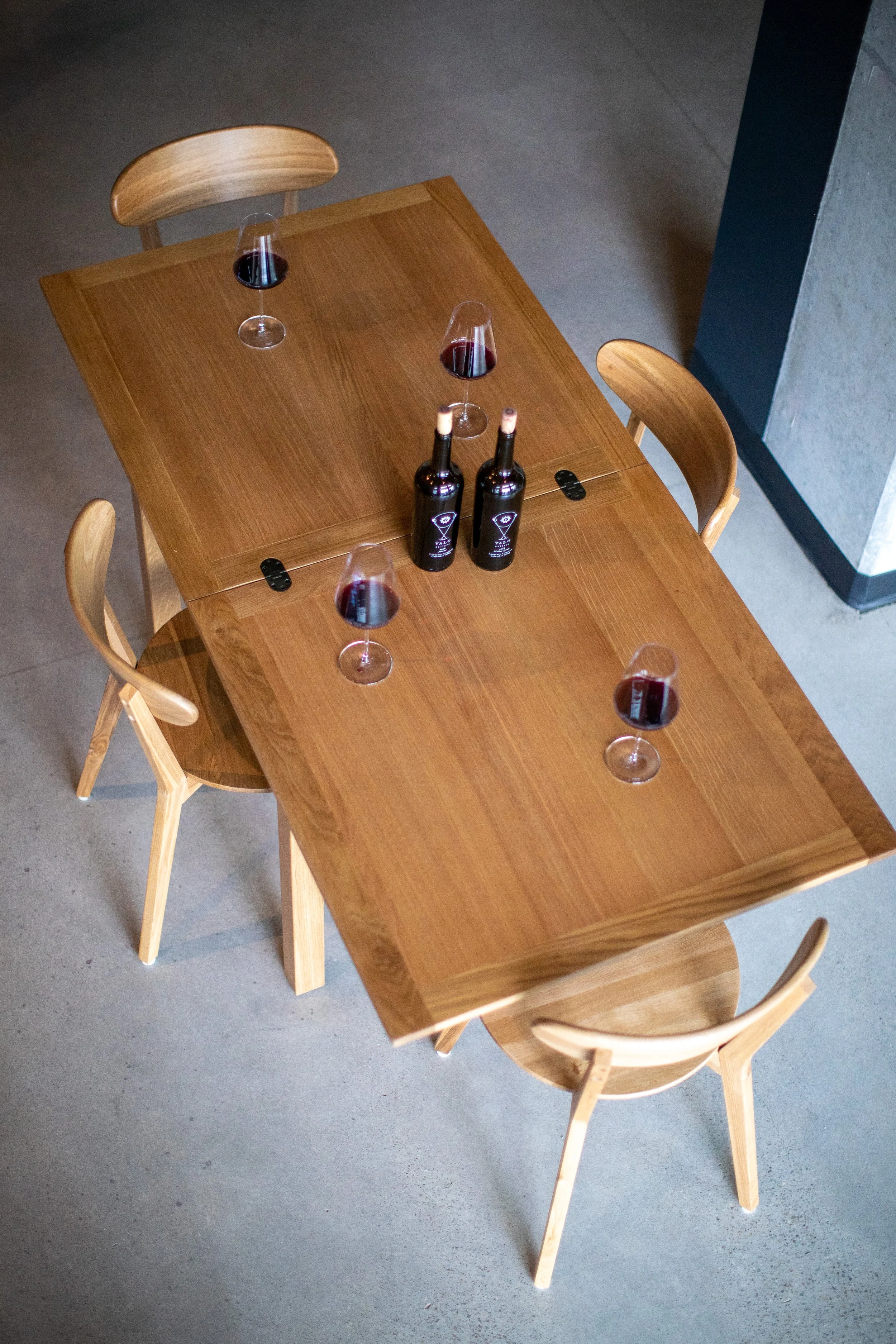 Image shot from above of handmade wood table at Valo's Vancouver tasting room