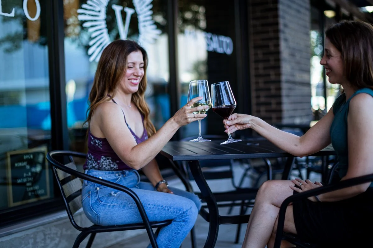 Two women enjoying wine on the patio at Valo's Vancouver tasting room