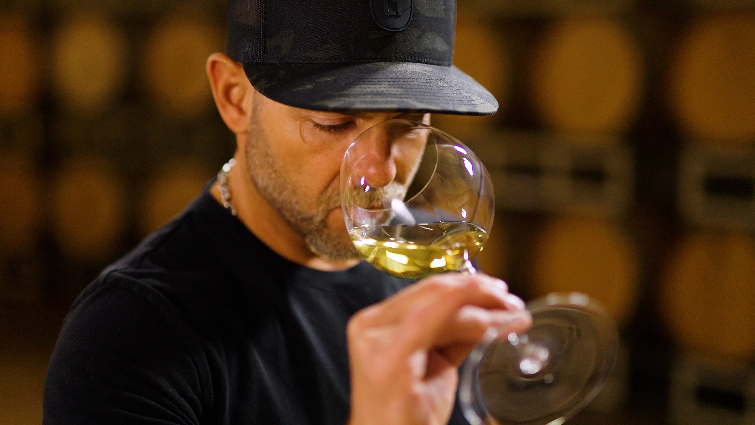 Valo's winemaker, Matias Kusulas, examining and smelling a white wine