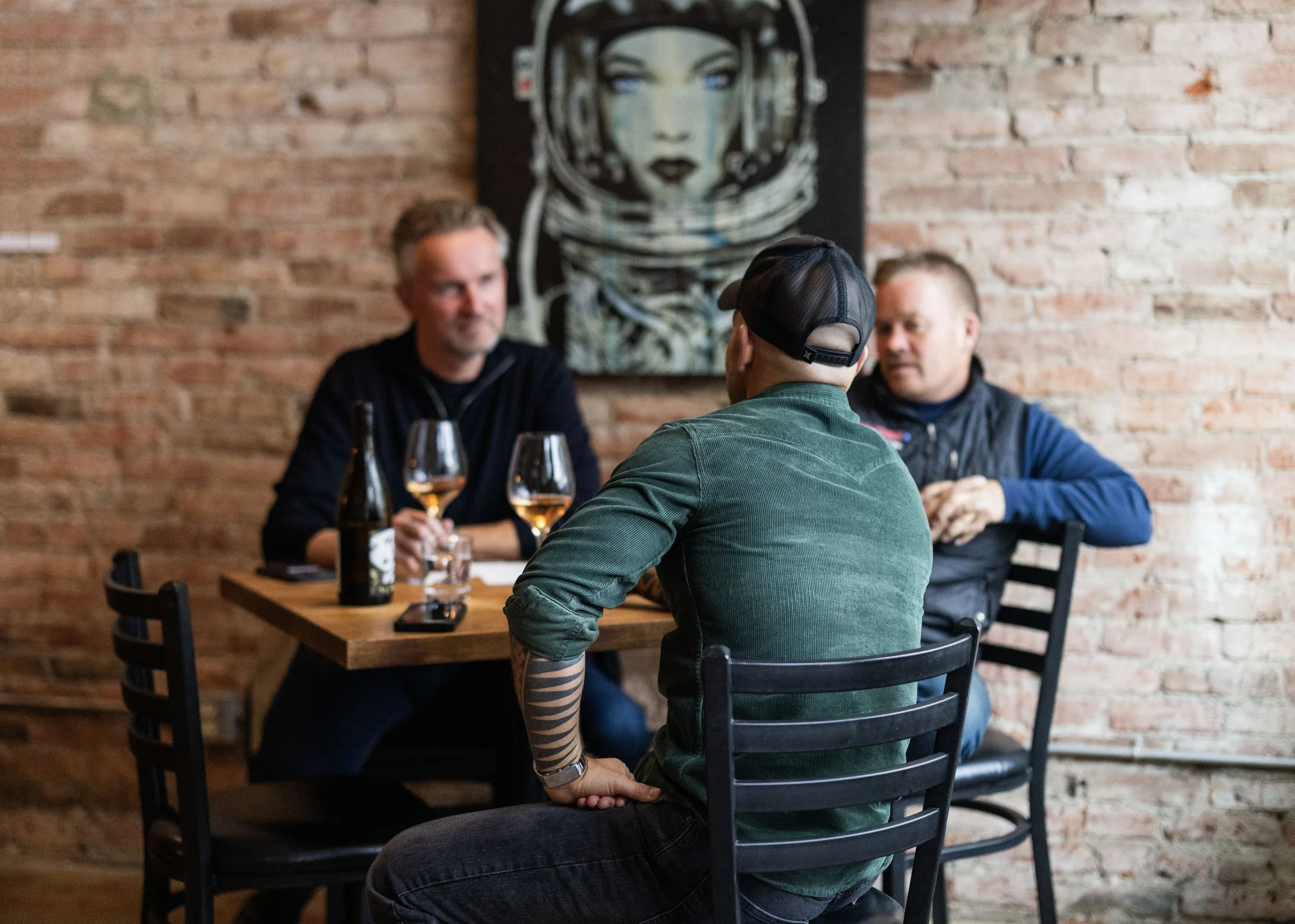 Three men enjoying wine at Valo's Ellensburg Tasting Room