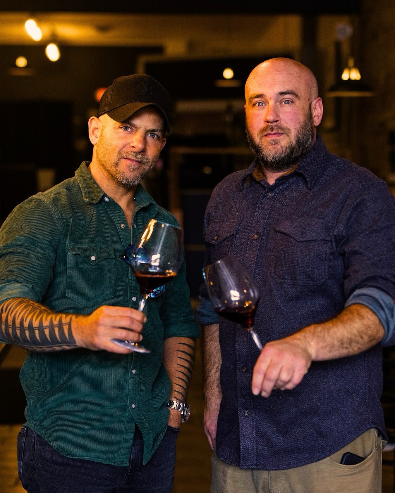 Valo's owner Michael Ruhland and winemaker Matias Kusulas with glasses of red wine