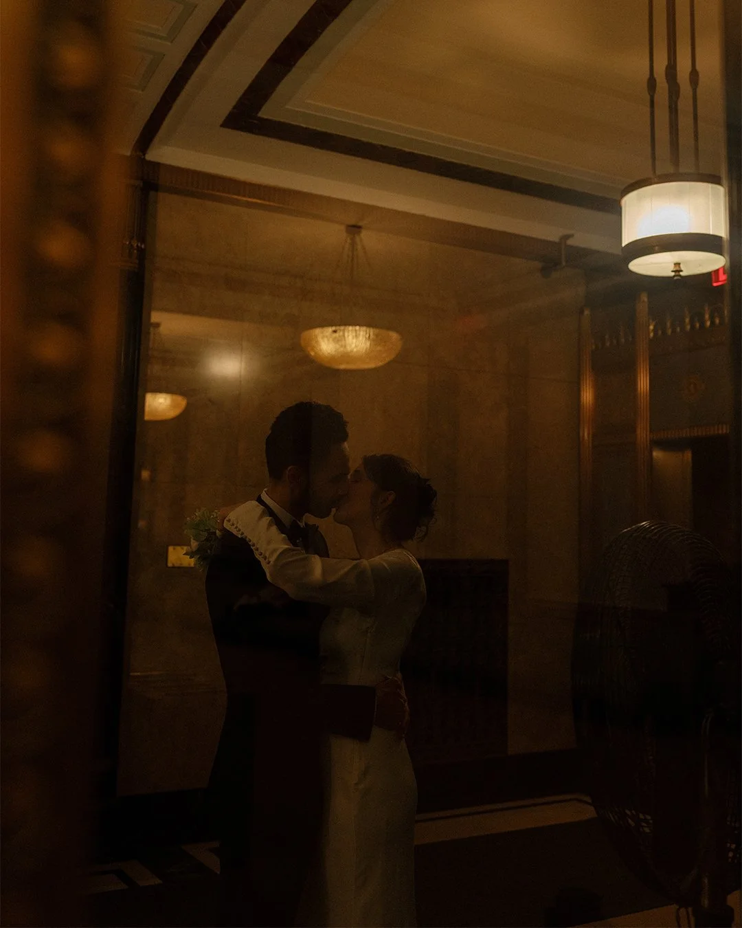 Couple kissing inside NYC City Hall after marriage ceremony