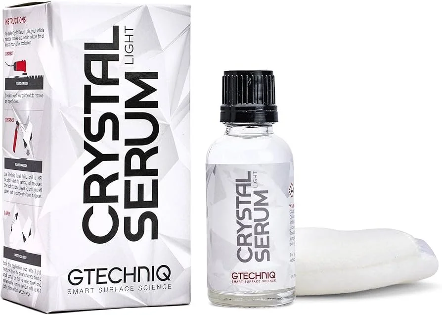 A box labeled 'Crystal Serum Light' from GTECHNIQ, a small bottle labeled 'Crystal Serum Light,' and a white applicator cloth.