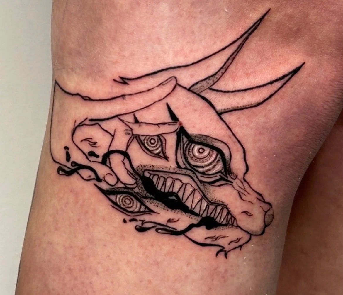 Black line tattoo of a hand making the OK sign, with a dragon's head and body intertwined with the hand, on skin.