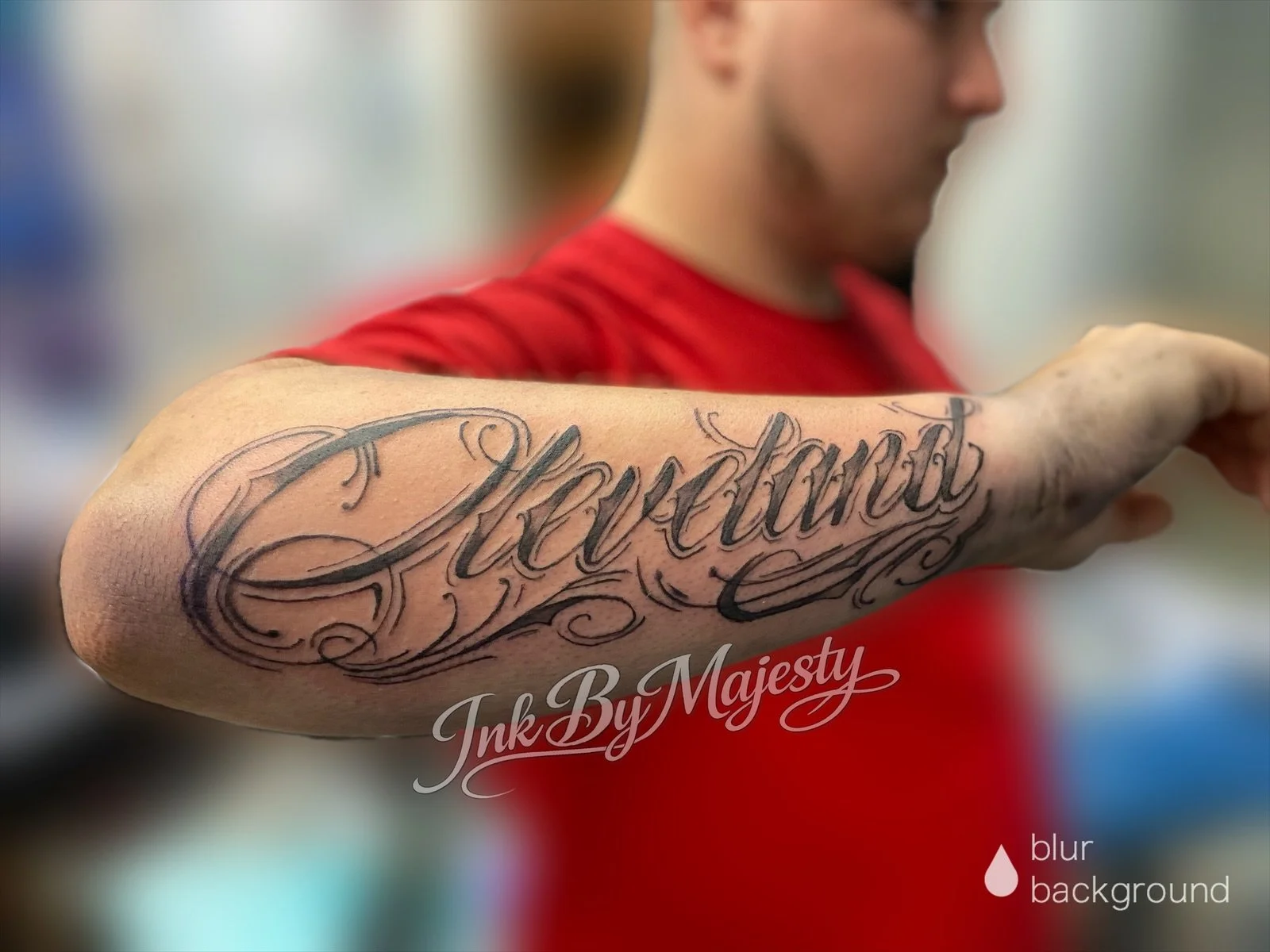 A person with a tattoo on their forearm that reads 'Lexi' in elaborate cursive font.