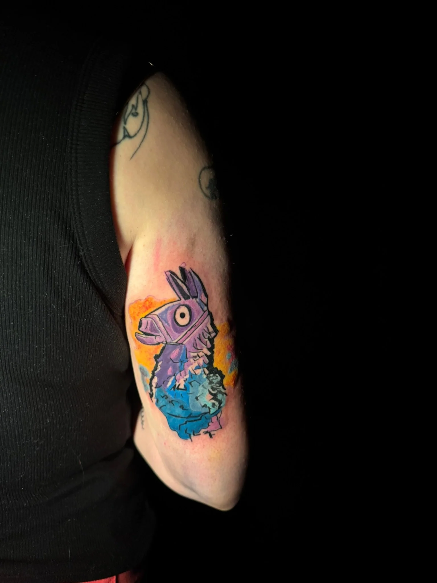 coloful tattoo design in the upper arm