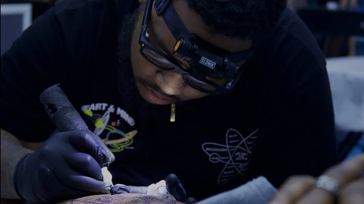 black tattoo artist in atlanta in session