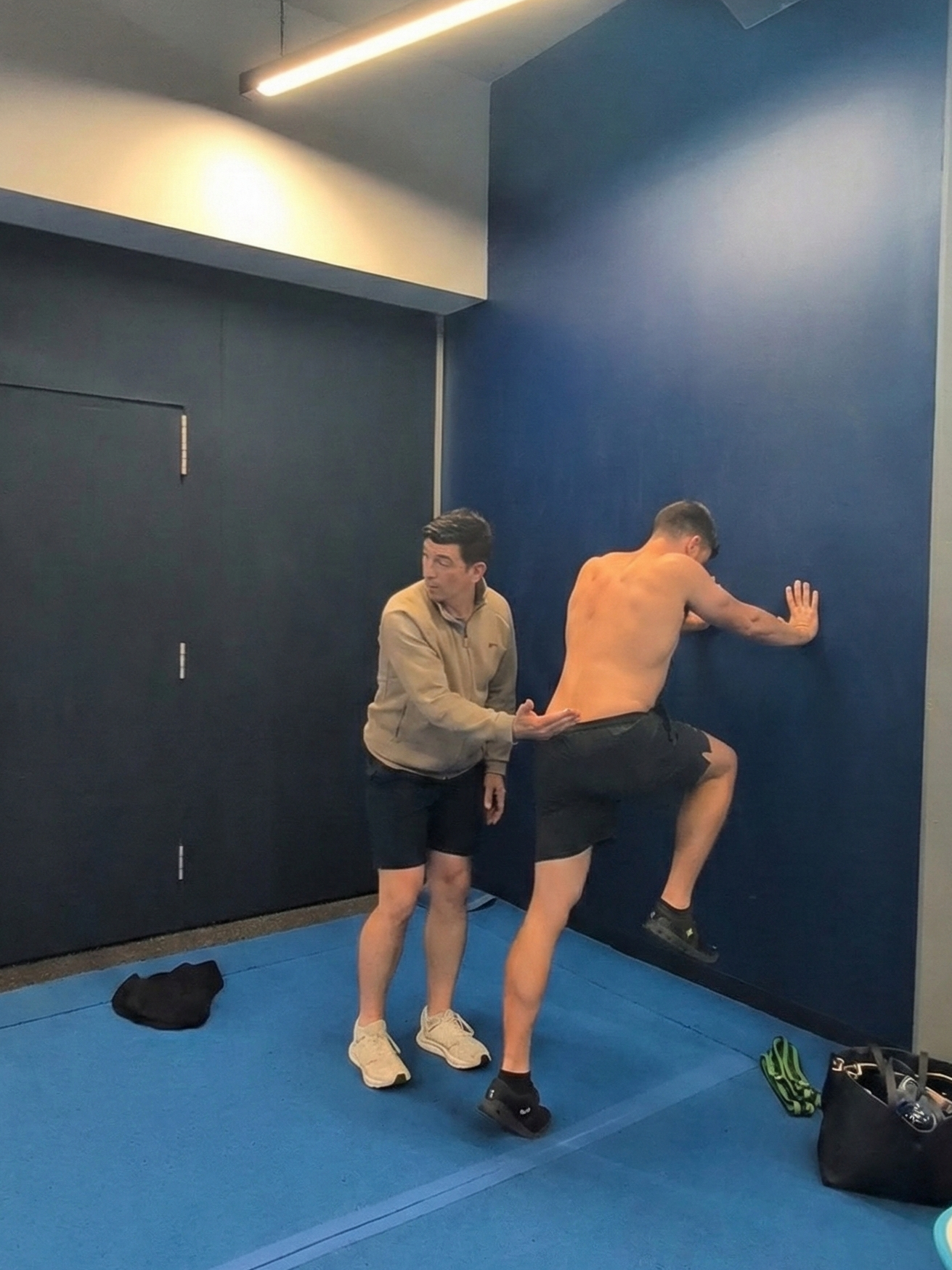 Enda King and Andrew Walker performing a biomechanical hip lock assessment at a sports physiotherapy workshop.