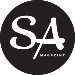 Logo with white text 'SA' and 'MAGAZINE' on a black circular background.