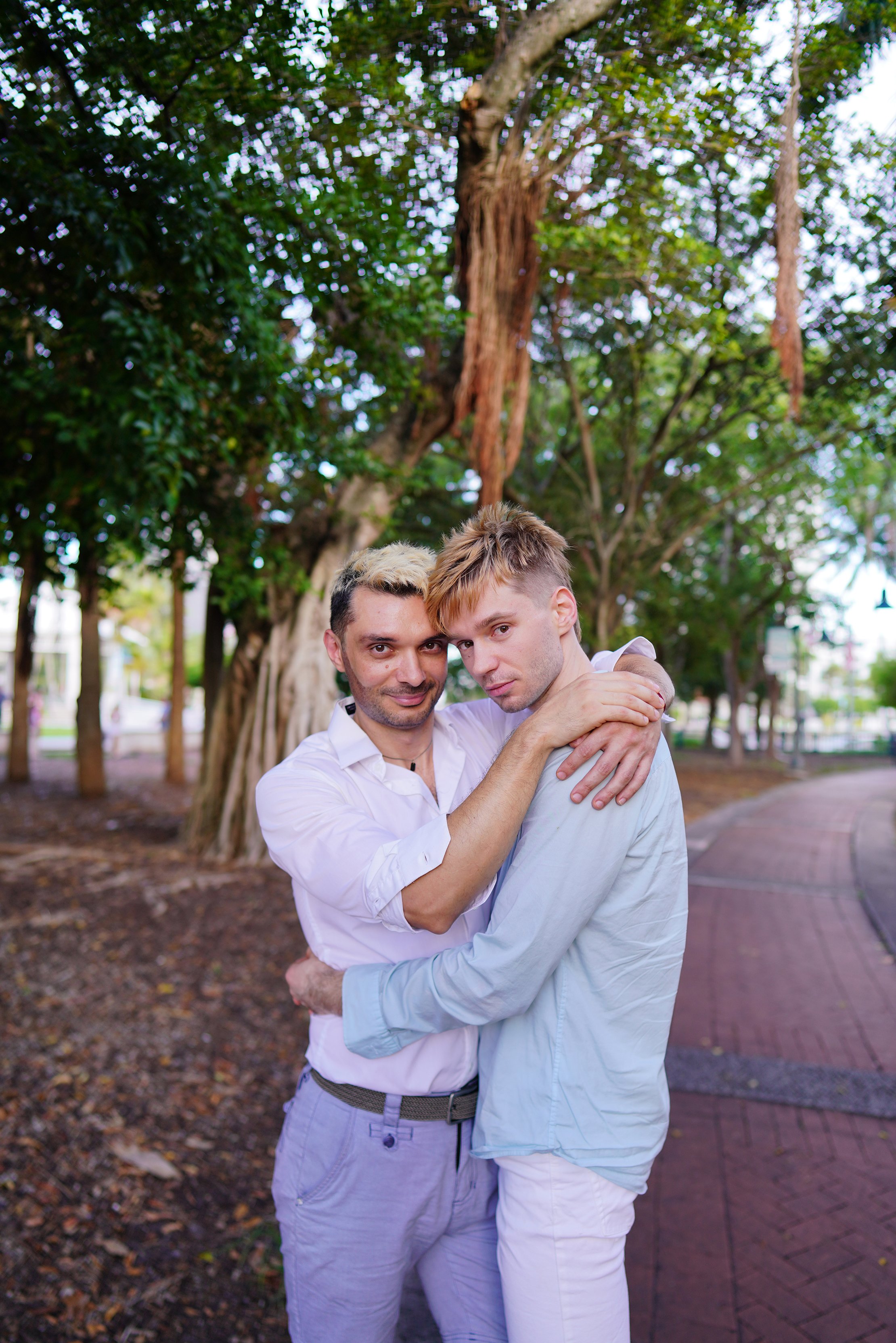 A quiet, emotional moment between two grooms sharing a forehead touch, photographed by a San Francisco-based luxury wedding photographer.