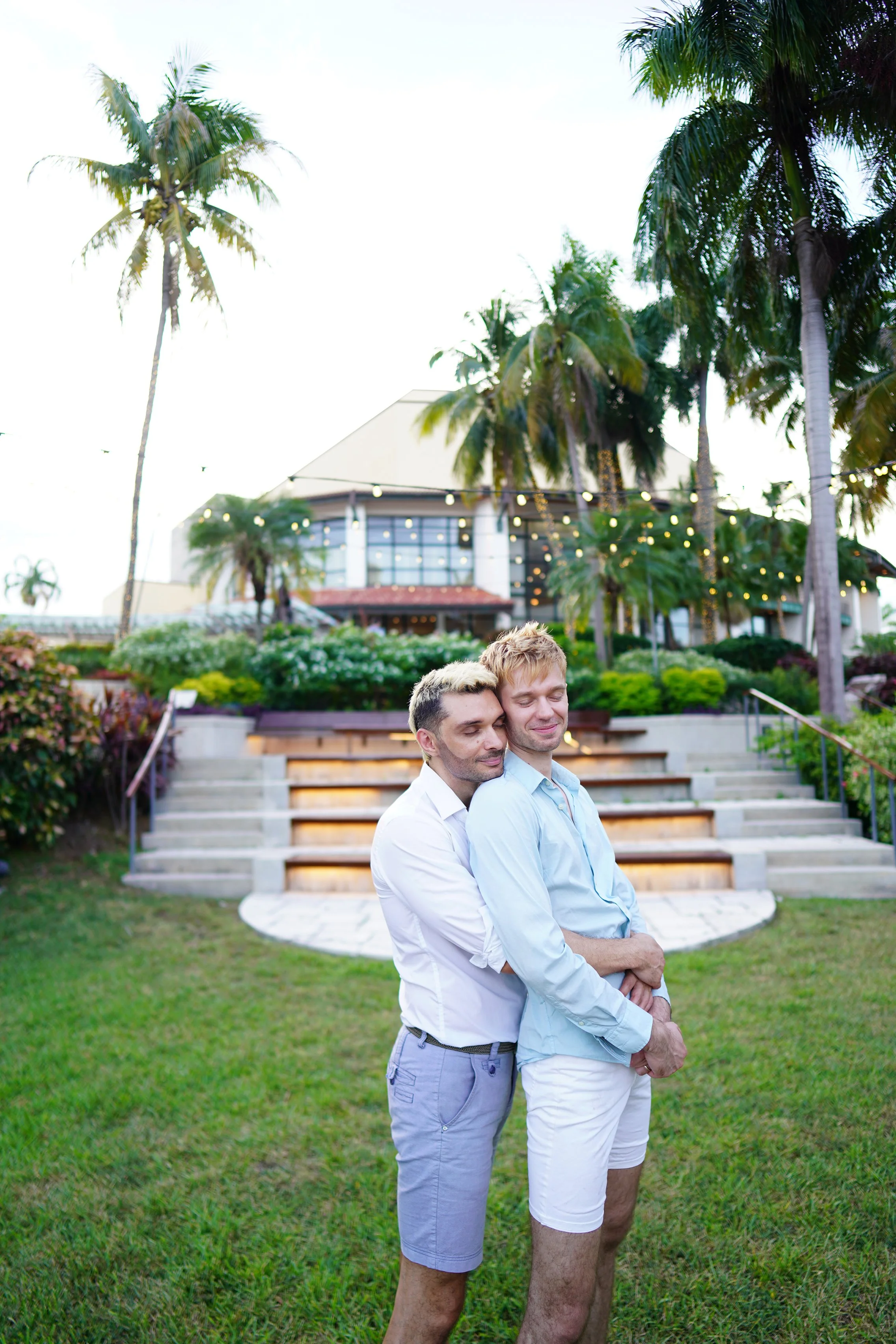 Artistic and intimate gay wedding photography in Florida by a luxury wedding photographer based in San Francisco, capturing a couple hugging and kissing with closed eyes.