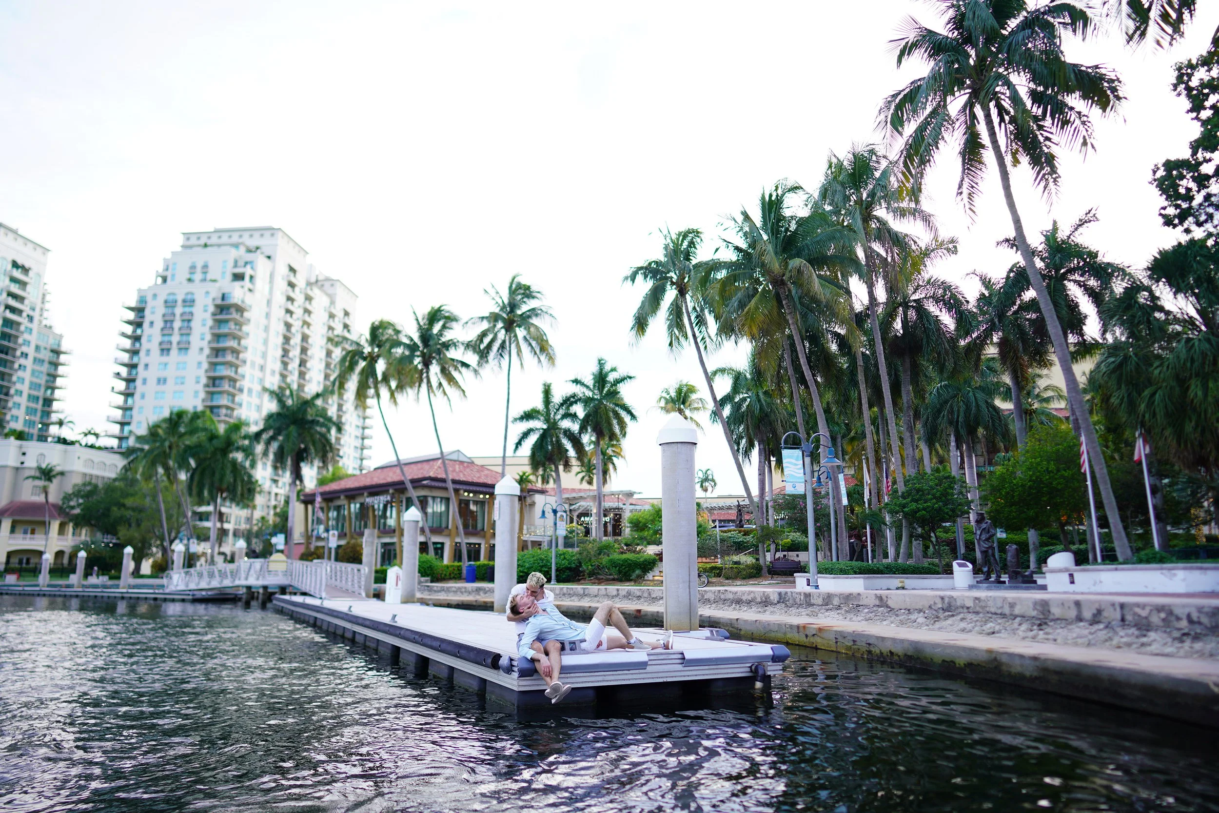 Grooms sharing a romantic moment on a wooden dock in Fort Lauderdale, captured by a professional photographer based in San Francisco, California.