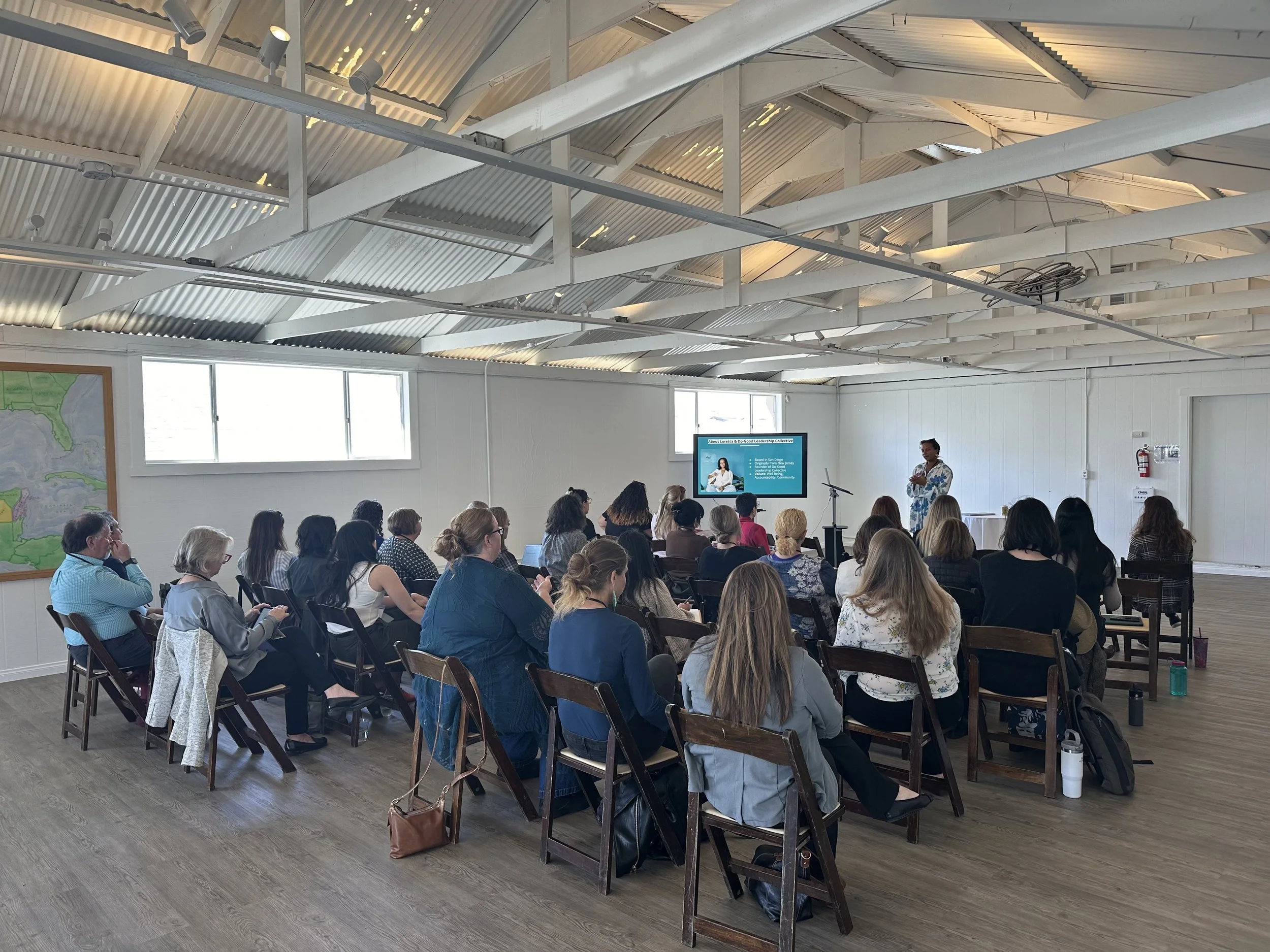 Facilitator presenting a leadership workshop to an audience of nonprofit professionals.