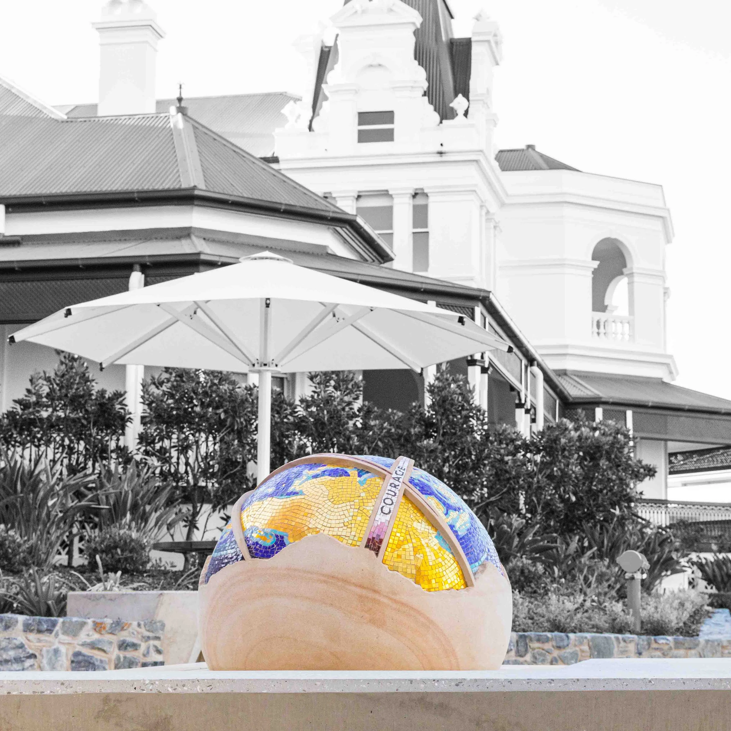 The St Rita's College Trinity Centre greets visitors with a stunning hand-carved sandstone sculpture of the Earth, adorned with Orsoni smalti and gold leaf tesserae. 