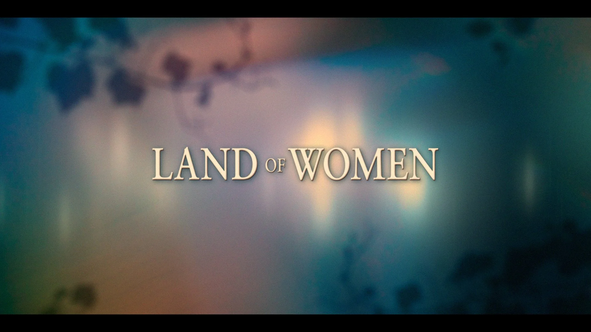 Title screen of 'Land of Women' with a colorful abstract background.