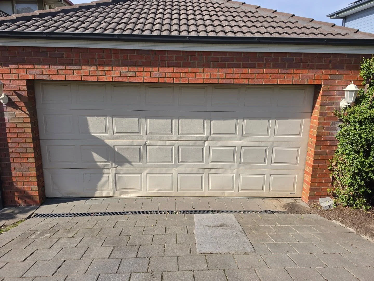 This was a make-safe we did a few months back, and we made sure the clients had full use of their door until the new one could be fitted.

The Colorbond Monument definitely looks a lot better than the old, faded Classic Cream door.

We paired this St