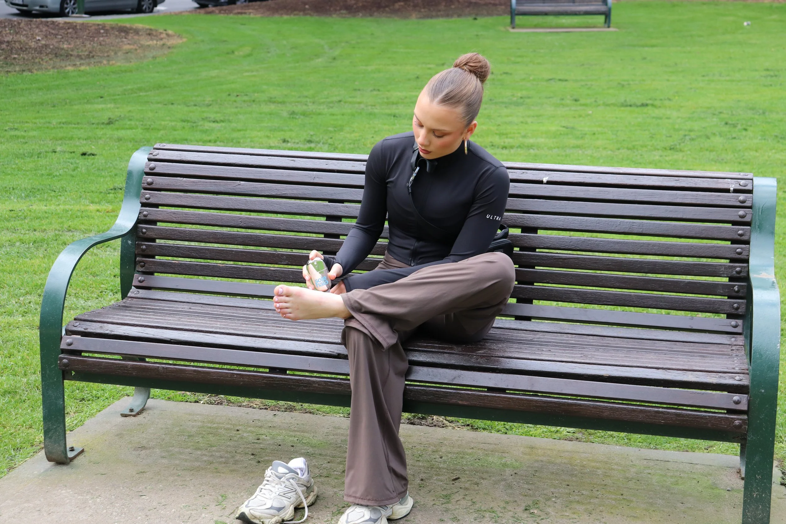 Model spraying sole halo at  apark bench