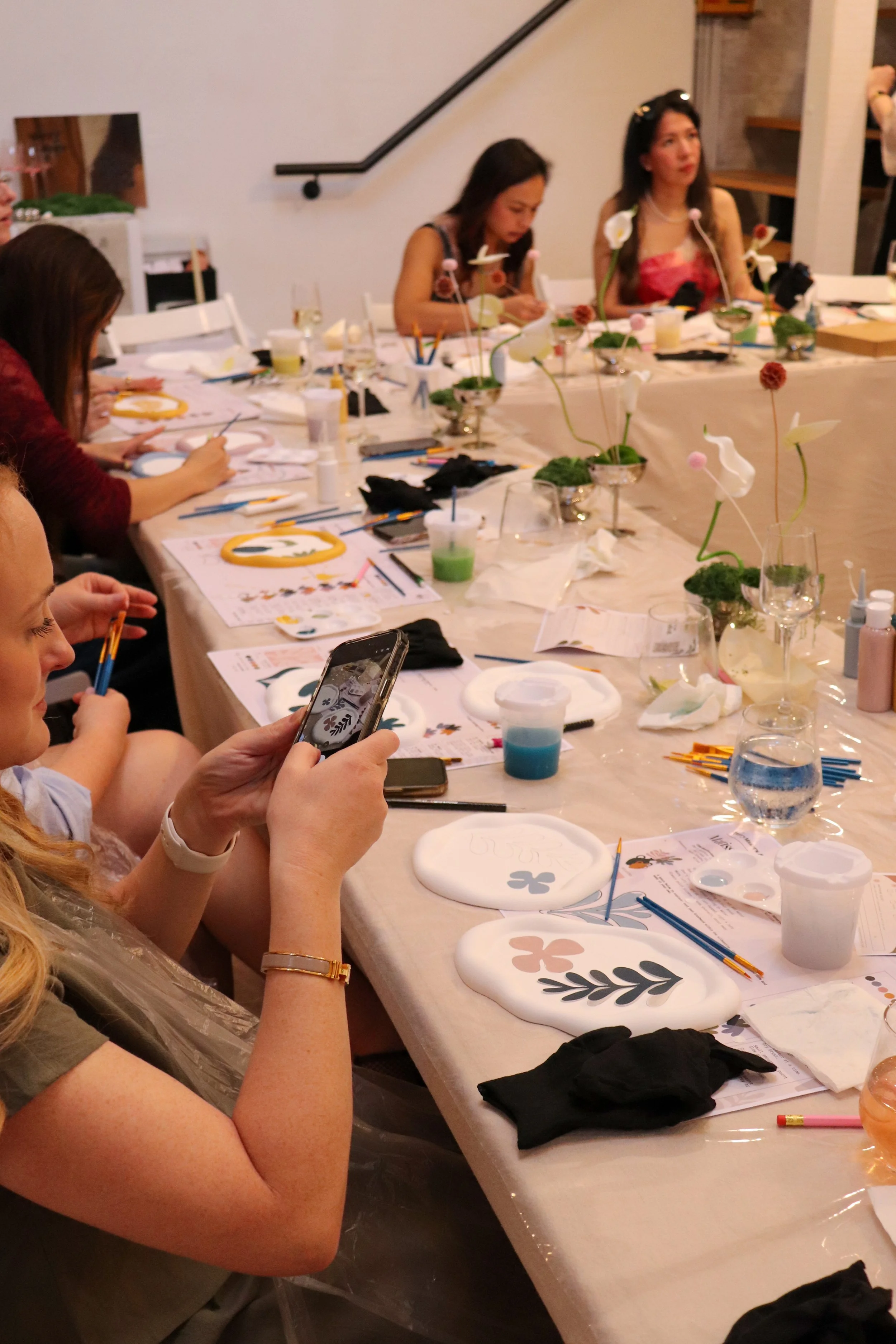 Attendees taking photo of their painted trays