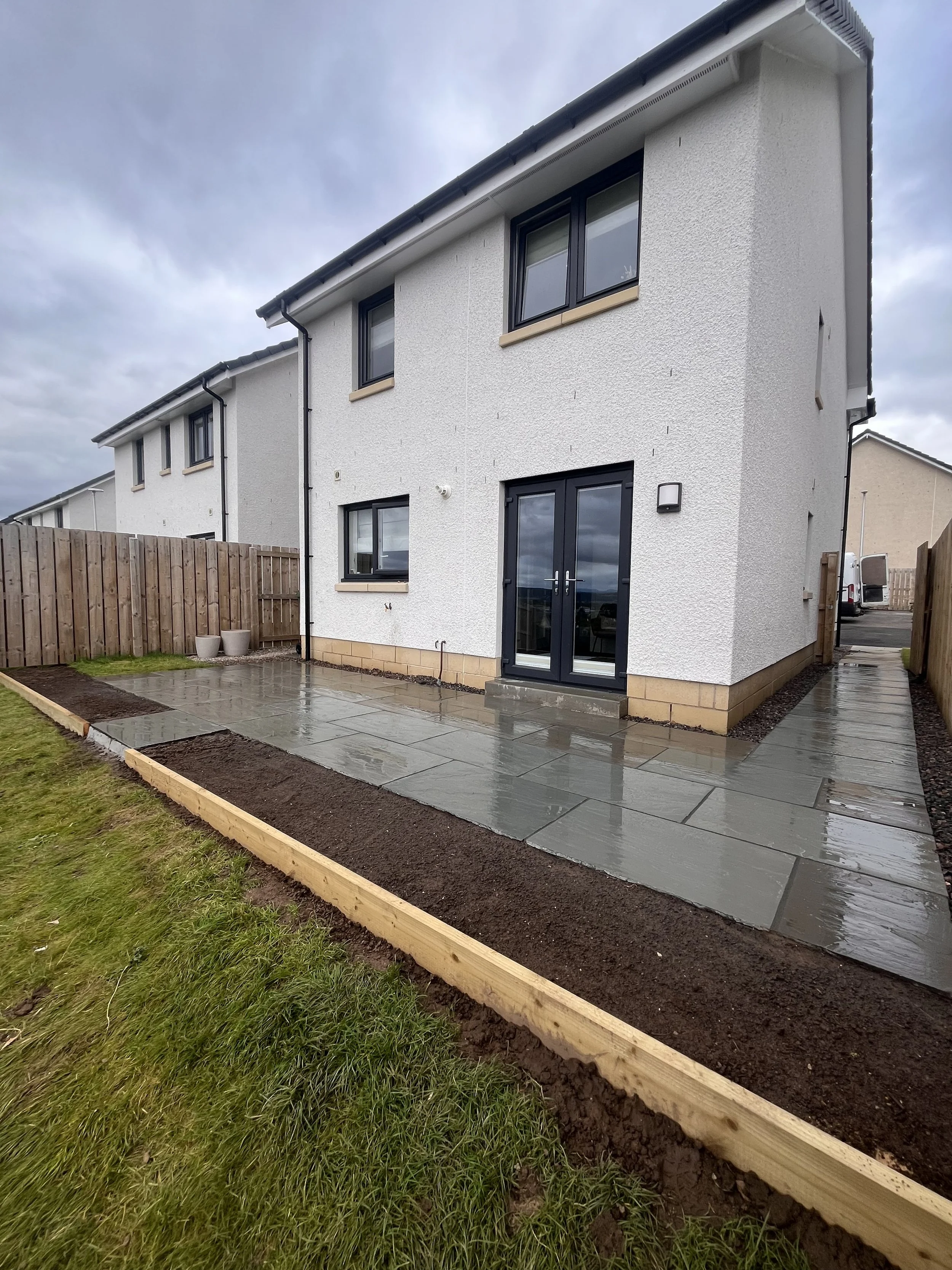 sandstone patio and raised flower beds