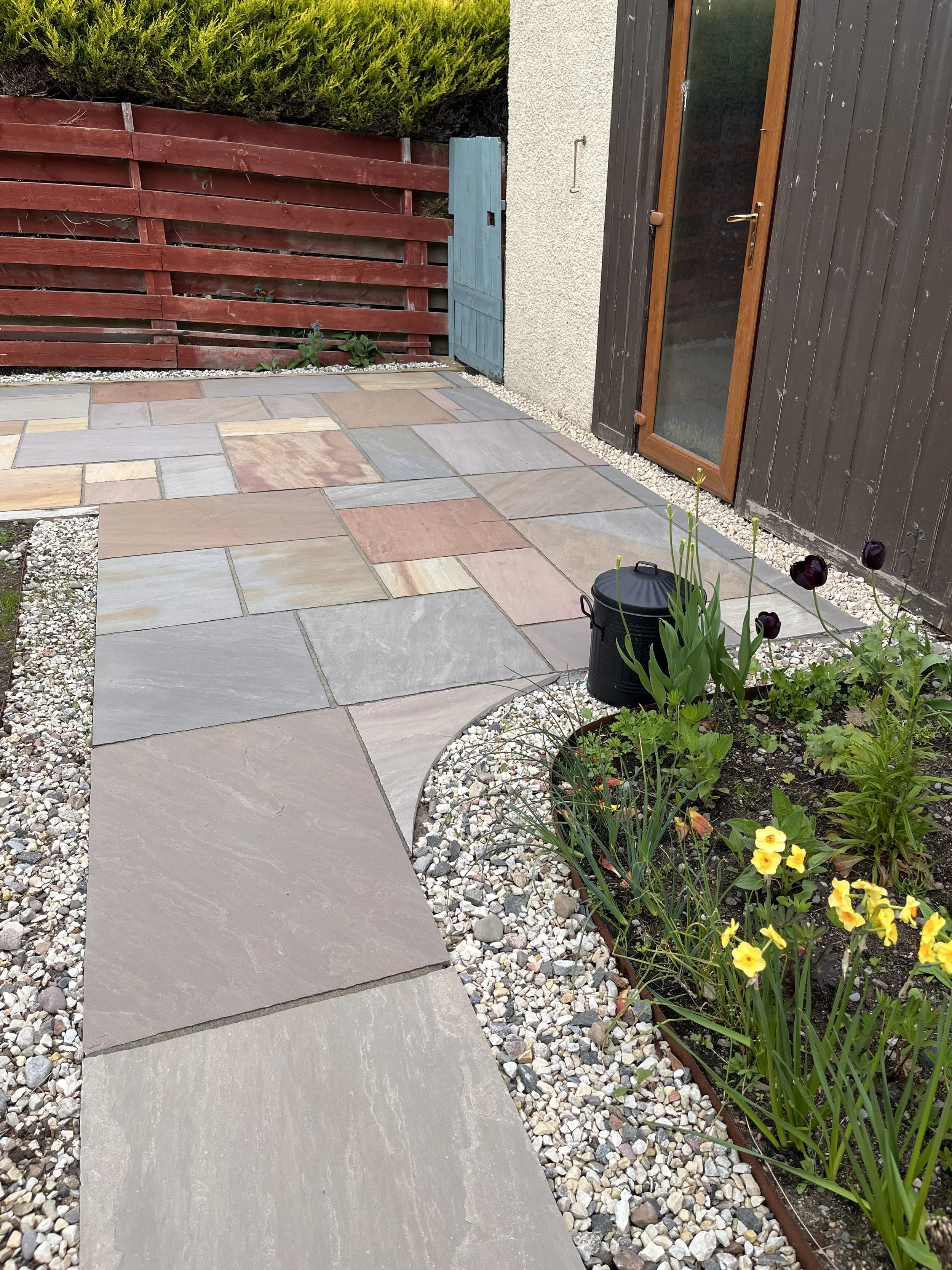 sandstone patio and flowerbed