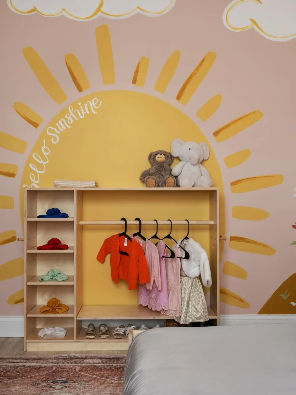 Local artist in Athens GA collaboration for an immersive little girl's bedroom design with a montessori style. Bright "hello sunshine" behind a kid's size getting ready area.