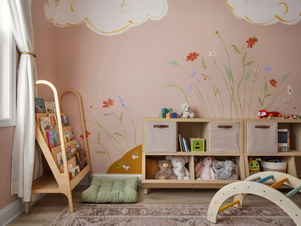 Local artist in Athens GA collaboration for an immersive little girl's bedroom design with a montessori style. Book reading area with Montessori shelving