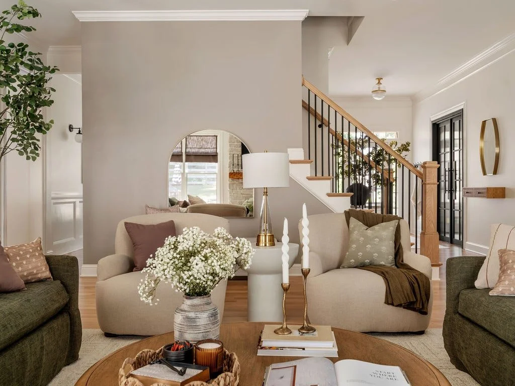 Custom family renovated living room with Griege accent wall and traditional profiel wingback chairs